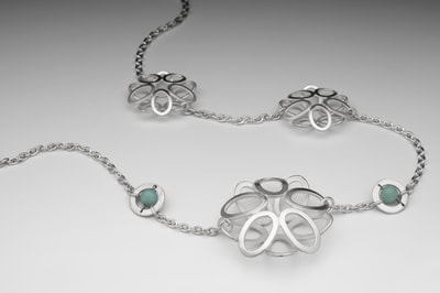 Assymetric silver necklace with apatite beads.