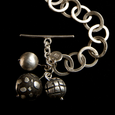Silver link bracelet with T-bar charms.