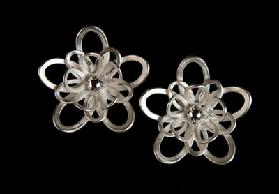 Large silver lily earrings.